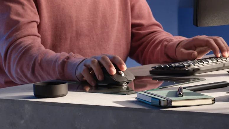 person-using-logitech-mx-master-3s-on-glass-surface